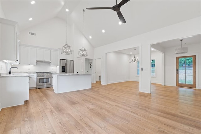 102-A S Cay Dr, Milledgeville, GA 31061 - kitchen with stainless steel appliances, a kitchen island, high vaulted ceiling, a chandelier, and light countertops