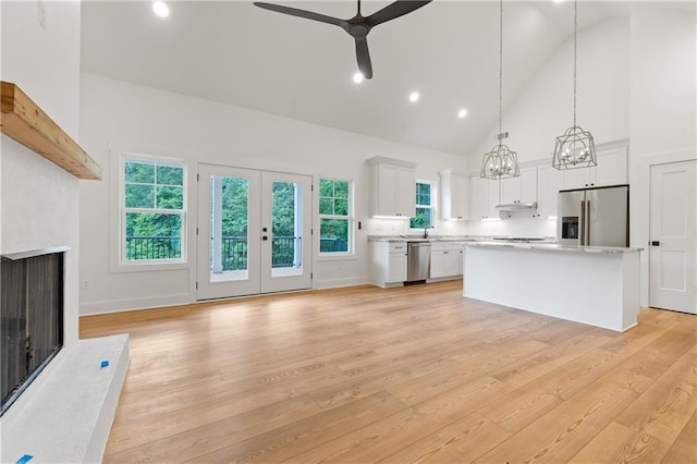 102-A S Cay Dr, Milledgeville, GA 31061 - kitchen featuring stainless steel appliances, high vaulted ceiling, light countertops, a ceiling fan, and a fireplace with raised hearth