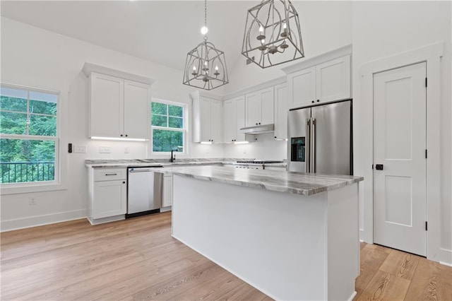 102-A S Cay Dr, Milledgeville, GA 31061 - kitchen with stainless steel appliances, a chandelier, under cabinet range hood, and white cabinets