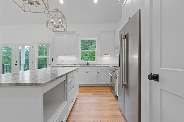 102-A S Cay Dr, Milledgeville, GA 31061 - kitchen featuring high end appliances, white cabinetry, a chandelier, and a center island