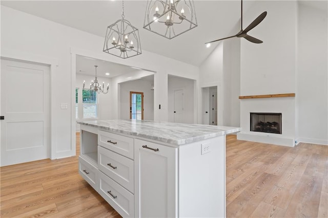 102-A S Cay Dr, Milledgeville, GA 31061 - kitchen featuring a chandelier, white cabinets, light wood-style floors, hanging light fixtures, and lofted ceiling