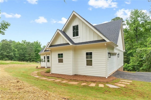 102-A S Cay Dr, Milledgeville, GA 31061 - view of side of home featuring board and batten siding, driveway, a shingled roof, and a lawn