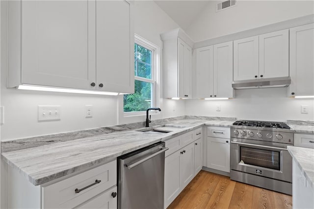 102-A S Cay Dr, Milledgeville, GA 31061 - kitchen featuring appliances with stainless steel finishes, under cabinet range hood, a sink, white cabinets, and light stone countertops