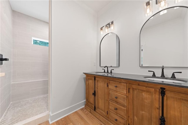 102-A S Cay Dr, Milledgeville, GA 31061 - bathroom with wood finished floors, double vanity, a walk in shower, baseboards, and ornamental molding