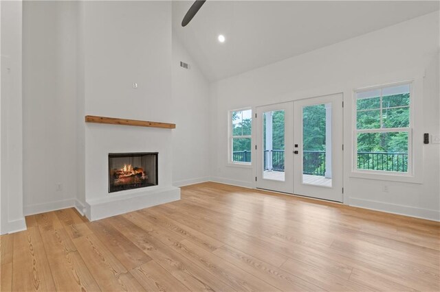 102-A S Cay Dr, Milledgeville, GA 31061 - unfurnished living room featuring high vaulted ceiling, a warm lit fireplace, ceiling fan, light wood-style flooring, and baseboards