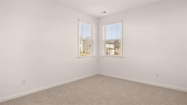 1139 Blue Juniper Cir, Loganville, GA 30052 - spare room featuring light colored carpet, baseboards, and visible vents