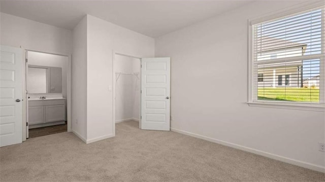 1139 Blue Juniper Cir, Loganville, GA 30052 - unfurnished bedroom featuring light carpet, baseboards, and a closet