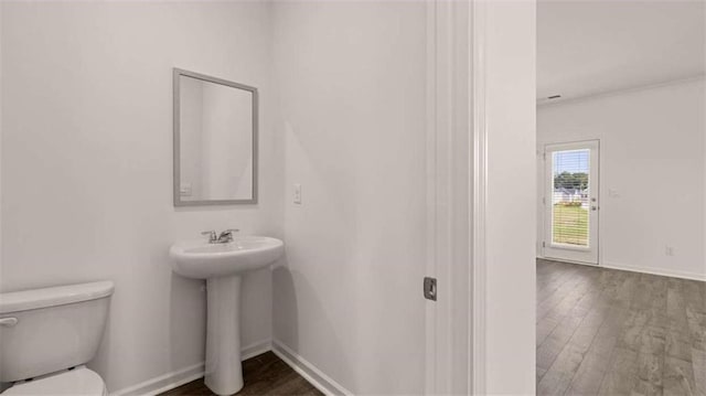 1139 Blue Juniper Cir, Loganville, GA 30052 - half bath featuring toilet, wood finished floors, and baseboards
