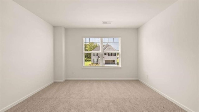 1139 Blue Juniper Cir, Loganville, GA 30052 - empty room featuring visible vents, light colored carpet, and baseboards