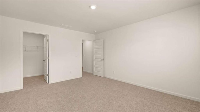 1139 Blue Juniper Cir, Loganville, GA 30052 - unfurnished bedroom featuring a spacious closet, light colored carpet, baseboards, and a closet