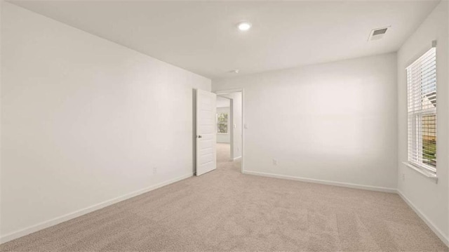 1139 Blue Juniper Cir, Loganville, GA 30052 - spare room with visible vents, baseboards, and light colored carpet
