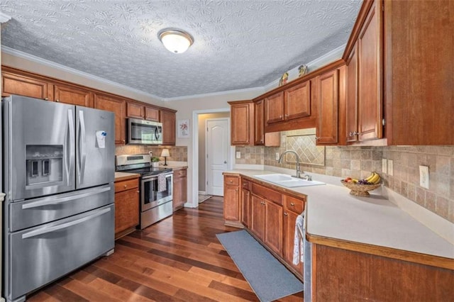 42 Hummingbird Ct, Jefferson, GA 30549 - kitchen with appliances with stainless steel finishes, a sink, brown cabinetry, dark wood finished floors, and light countertops