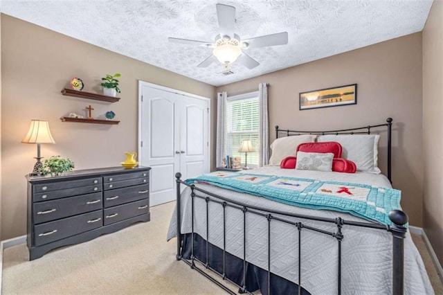 42 Hummingbird Ct, Jefferson, GA 30549 - bedroom featuring baseboards, light carpet, a closet, a textured ceiling, and a ceiling fan