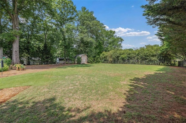42 Hummingbird Ct, Jefferson, GA 30549 - view of grassy yard featuring a storage unit and an outbuilding