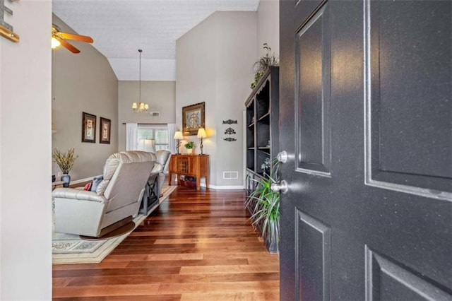 42 Hummingbird Ct, Jefferson, GA 30549 - foyer with wood finished floors, high vaulted ceiling, a chandelier, ceiling fan, and baseboards