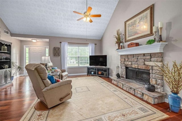 42 Hummingbird Ct, Jefferson, GA 30549 - living room with lofted ceiling, wood finished floors, a ceiling fan, a textured ceiling, and a stone fireplace