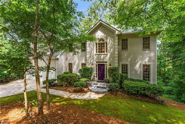 1950 Wenlok Trl NE, Marietta, GA 30066 - colonial home featuring stucco siding, driveway, a garage, and a front lawn