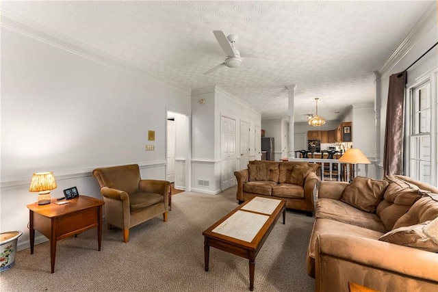 1950 Wenlok Trl NE, Marietta, GA 30066 - living room featuring a textured ceiling, crown molding, ornate columns, light carpet, and a ceiling fan