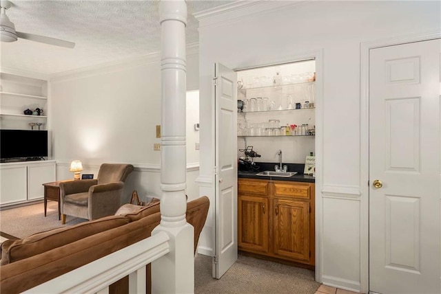 1950 Wenlok Trl NE, Marietta, GA 30066 - indoor wet bar featuring crown molding, ceiling fan, a textured ceiling, light colored carpet, and decorative columns