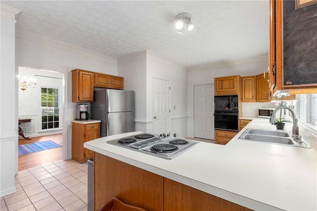 1950 Wenlok Trl NE, Marietta, GA 30066 - kitchen with black appliances, healthy amount of natural light, light countertops, and crown molding