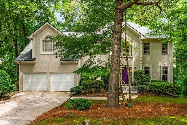 1950 Wenlok Trl NE, Marietta, GA 30066 - view of front of house featuring stucco siding, an attached garage, and driveway