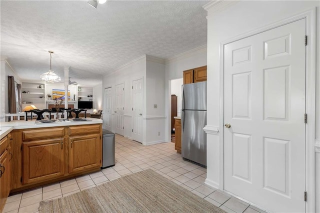1950 Wenlok Trl NE, Marietta, GA 30066 - kitchen featuring freestanding refrigerator, brown cabinets, light tile patterned flooring, a textured ceiling, and ornamental molding