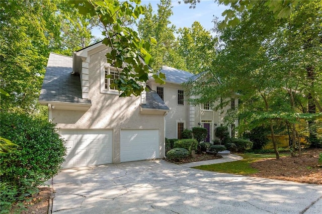 1950 Wenlok Trl NE, Marietta, GA 30066 - view of front of home with driveway, stucco siding, a garage, and a shingled roof