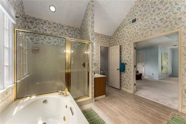 1950 Wenlok Trl NE, Marietta, GA 30066 - bathroom featuring lofted ceiling, a stall shower, a jetted tub, wallpapered walls, and wood finished floors