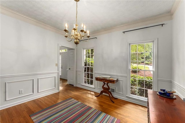 1950 Wenlok Trl NE, Marietta, GA 30066 - dining area with wood finished floors, a chandelier, plenty of natural light, crown molding, and a decorative wall