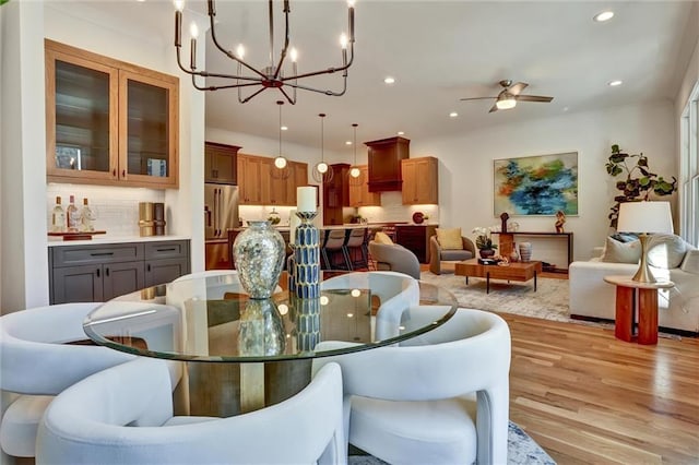 dining area featuring ceiling fan and light wood-type flooring