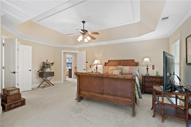 bedroom with a raised ceiling, crown molding, visible vents, light carpet, and baseboards