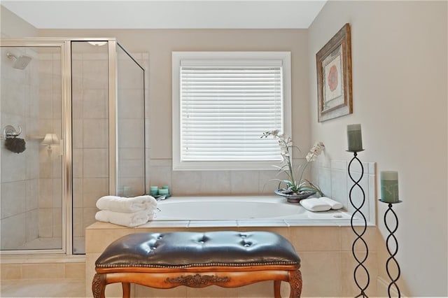bathroom featuring a bath and a shower stall