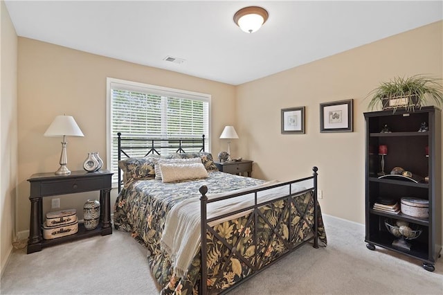 bedroom featuring baseboards, visible vents, and carpet flooring