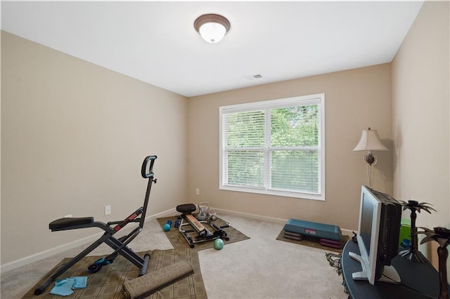 exercise room featuring visible vents, carpet, and baseboards