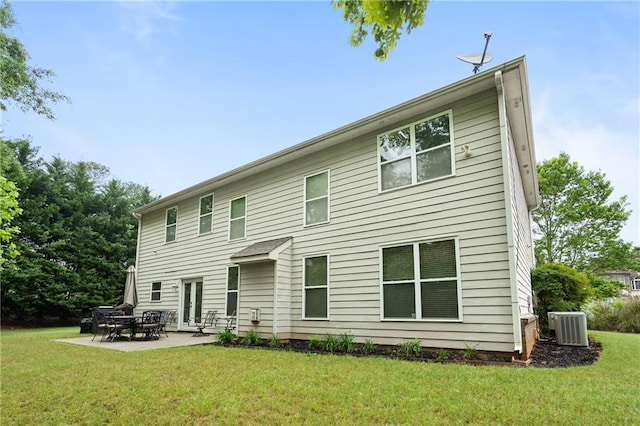 back of property with a yard, central AC, and a patio area