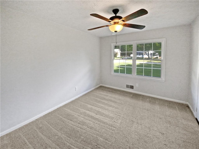 spare room with ceiling fan, carpet floors, and a textured ceiling