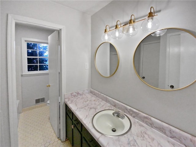 bathroom with tile patterned flooring and vanity