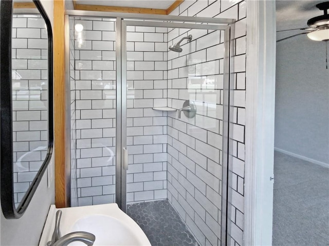 bathroom with ceiling fan and walk in shower