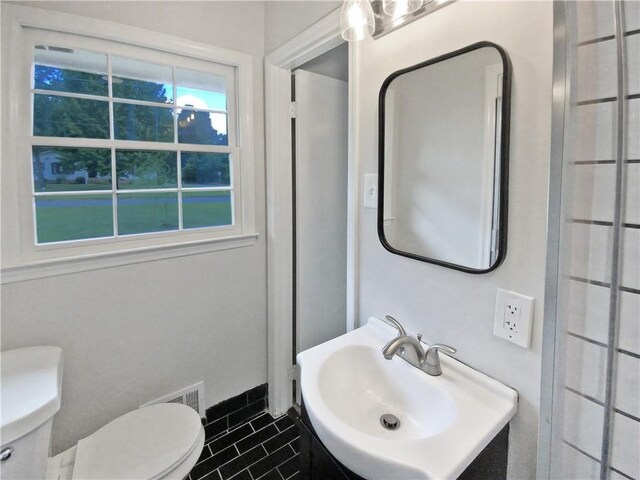 bathroom featuring tile patterned floors, vanity, and toilet