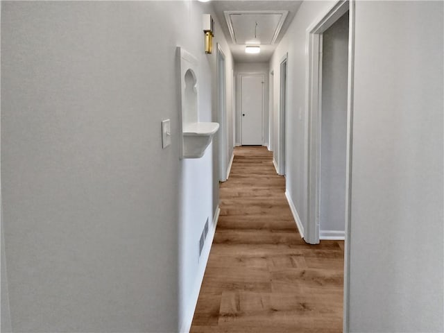 corridor with light wood-type flooring