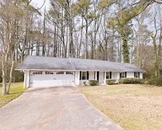 566 Sugar Valley Ln, Conyers, GA 30094 - single story home with driveway, an attached garage, and a front yard