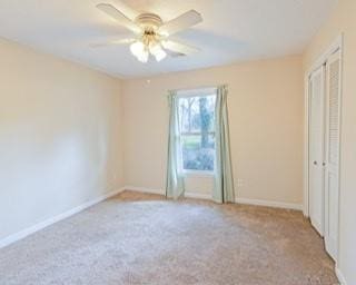 566 Sugar Valley Ln, Conyers, GA 30094 - unfurnished bedroom with carpet floors, ceiling fan, and baseboards