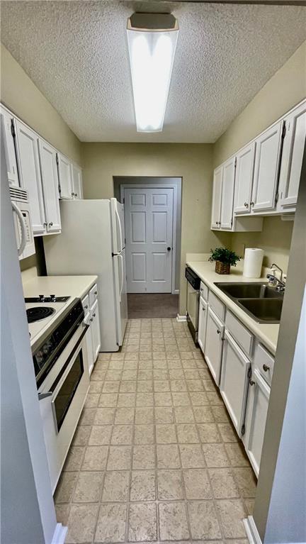 kitchen featuring white cabinets, white appliances, and sink