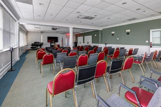 cinema room with a paneled ceiling, carpet floors, and crown molding