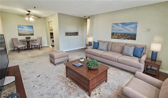 carpeted living room featuring ceiling fan