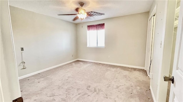 unfurnished bedroom with light carpet and ceiling fan