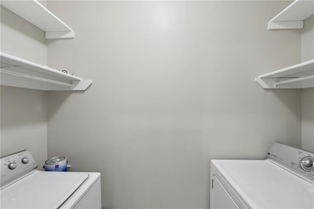 washroom with washing machine and clothes dryer and laundry area