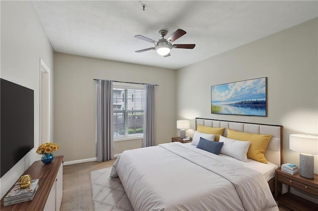 bedroom featuring ceiling fan, baseboards, and carpet