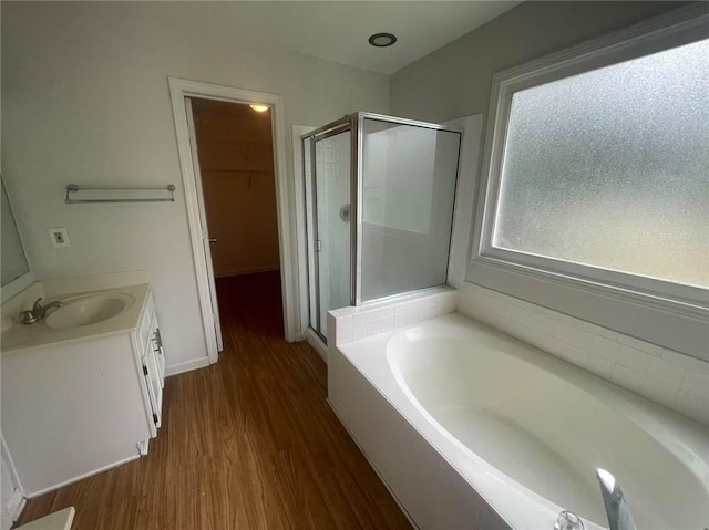 2994 Abbotts Oak Way, Duluth, GA 30097 - full bathroom featuring a stall shower, vanity, a bath, wood finished floors, and a walk in closet