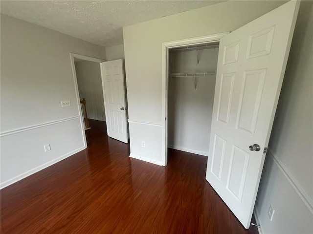 2994 Abbotts Oak Way, Duluth, GA 30097 - unfurnished bedroom featuring wood finished floors, a closet, and a textured ceiling